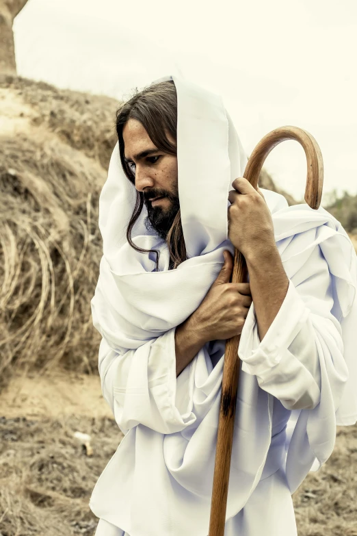 a man in a white robe holding a wooden stick, dressed like jesus christ, instagram post, contemplative, harvest