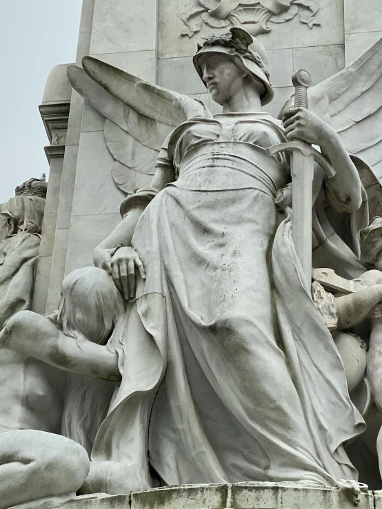 a statue of a woman holding a sword, inspired by Carel Willink, pexels contest winner, neoclassicism, angels protecting a praying man, alphonce mucha, giant grave structures, biblically accurate angels