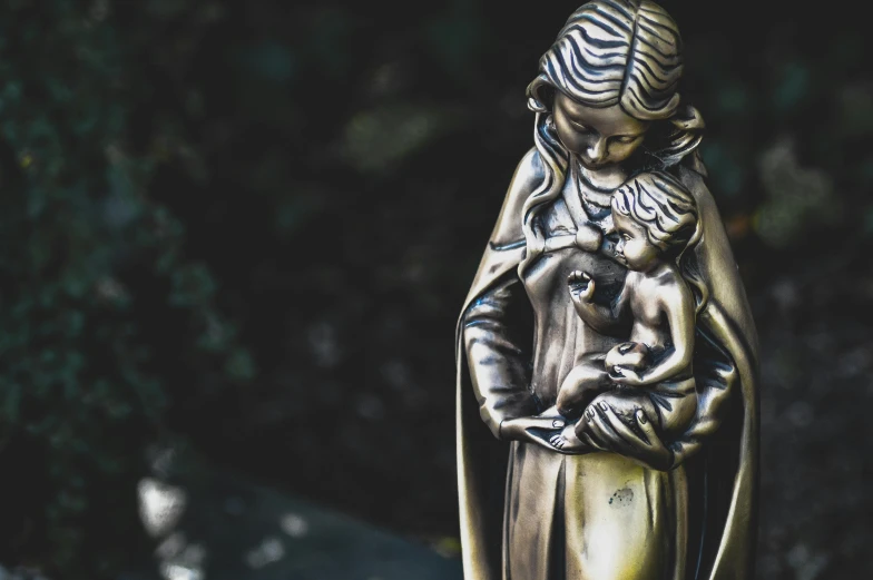 a statue of a woman holding a baby, a statue, by Adam Marczyński, pexels contest winner, art nouveau, reliquary, patron saint of 🛸🌈👩🏾, bronze statue and silver, catholic