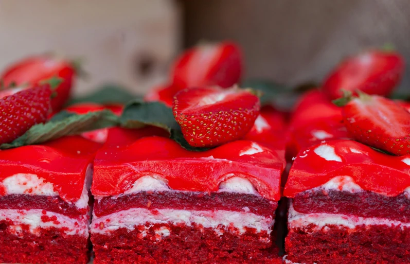 a close up of a red velvet cake with strawberries on top, a picture, by Adam Marczyński, pexels, hurufiyya, rectangle, red emerald, thumbnail, bakery