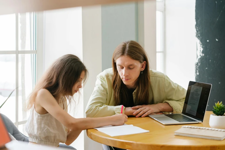 two women sitting at a table working on laptops, a drawing, by Nicolette Macnamara, pexels contest winner, lachlan bailey, drawing on a parchment, teacher, sitting on top a table