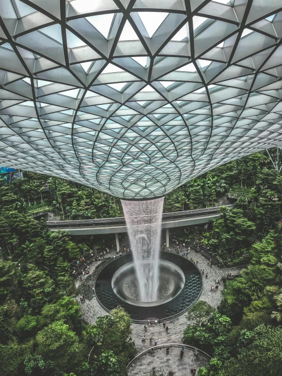 the inside of a building with a waterfall coming out of it, inspired by Paul Gustav Fischer, pexels contest winner, singapore, thumbnail, lush garden spaceship, superb detail 8 k