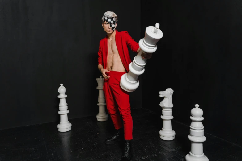 a man in a red suit playing a game of chess, an album cover, inspired by Horace Vernet, pexels contest winner, antipodeans, full body photoshoot, justin bieber, anna nikonova aka newmilky, avant garde fashion model