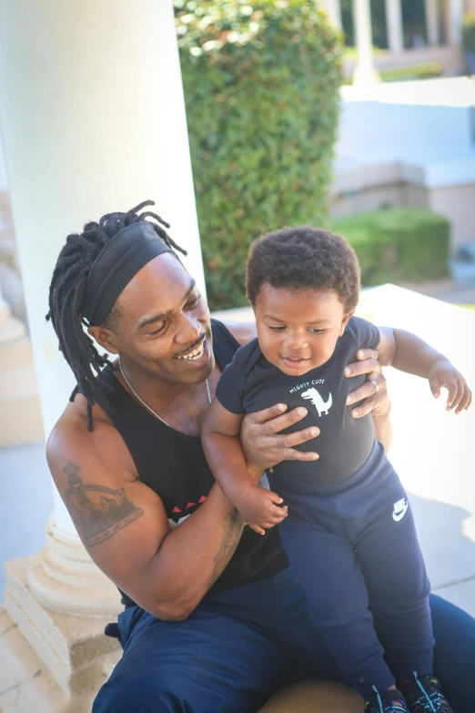 a man holding a small child on a porch, inspired by Terrell James, pexels contest winner, playboi carti portrait, athletic and strong, square, transparent background