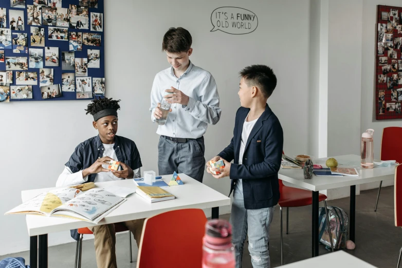 a group of people standing around a table, inspired by Gillis Rombouts, pexels contest winner, ashcan school, kids playing, standing in class, snacks, promo still