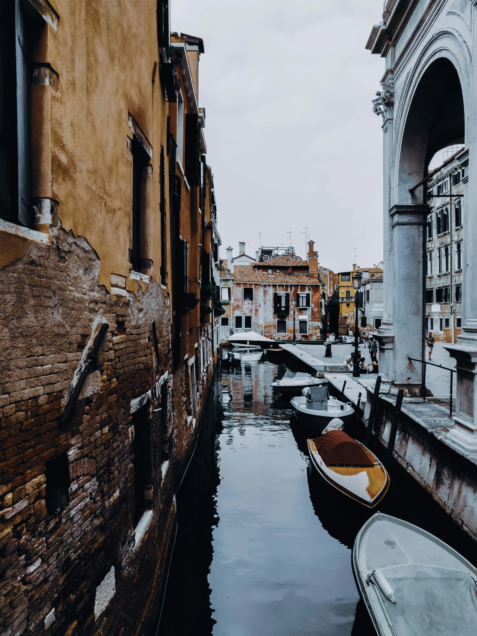 a couple of boats that are sitting in the water, inspired by Quirizio di Giovanni da Murano, pexels contest winner, narrow and winding cozy streets, moody details, today\'s featured photograph 4k, vermeer and caravaggio