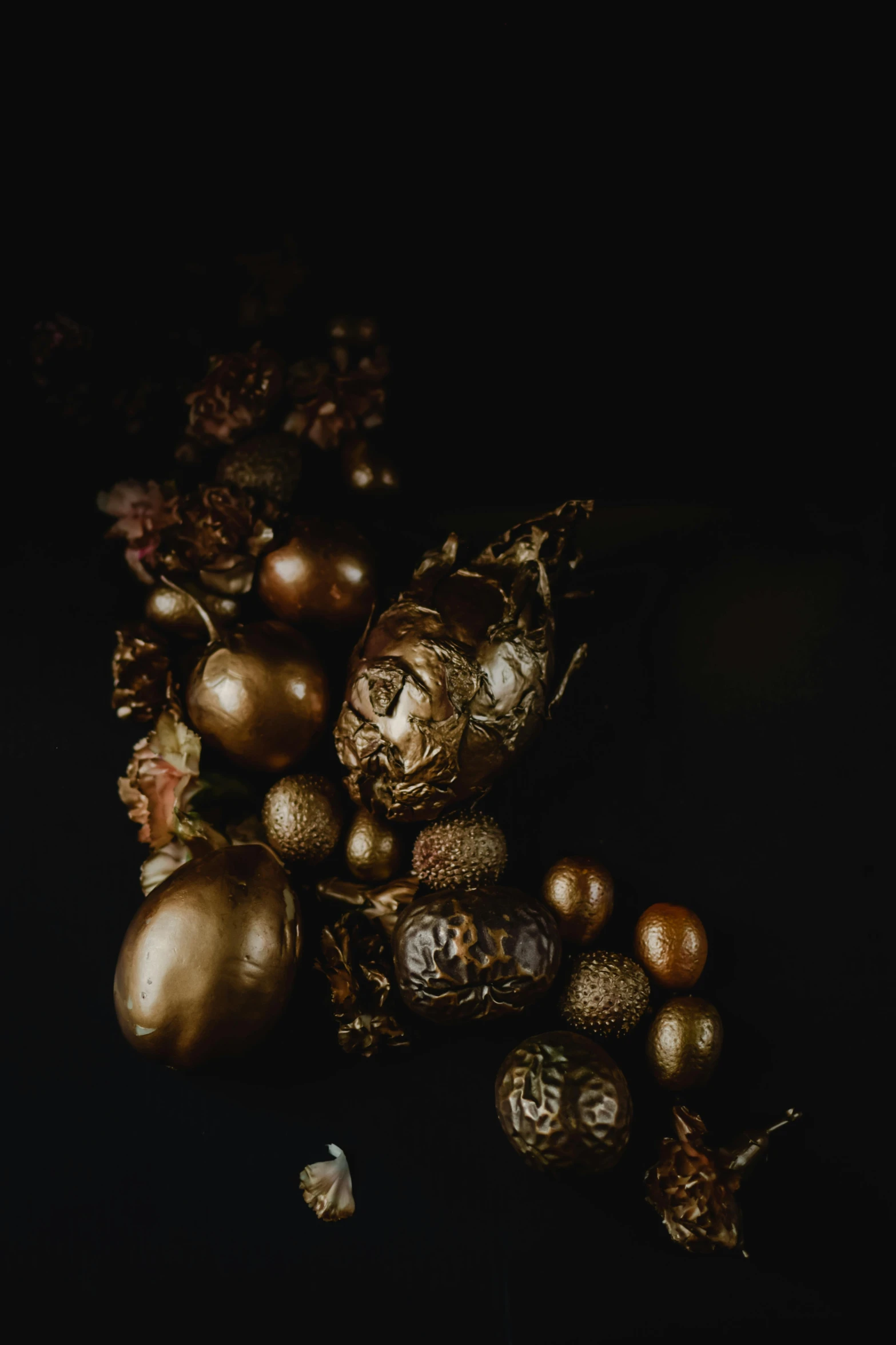 a bunch of gold ornaments sitting on top of a table, a still life, inspired by Jean Jouvenet, baroque, dark earthy colours, seeds, 'untitled 9 ', dragon eggs