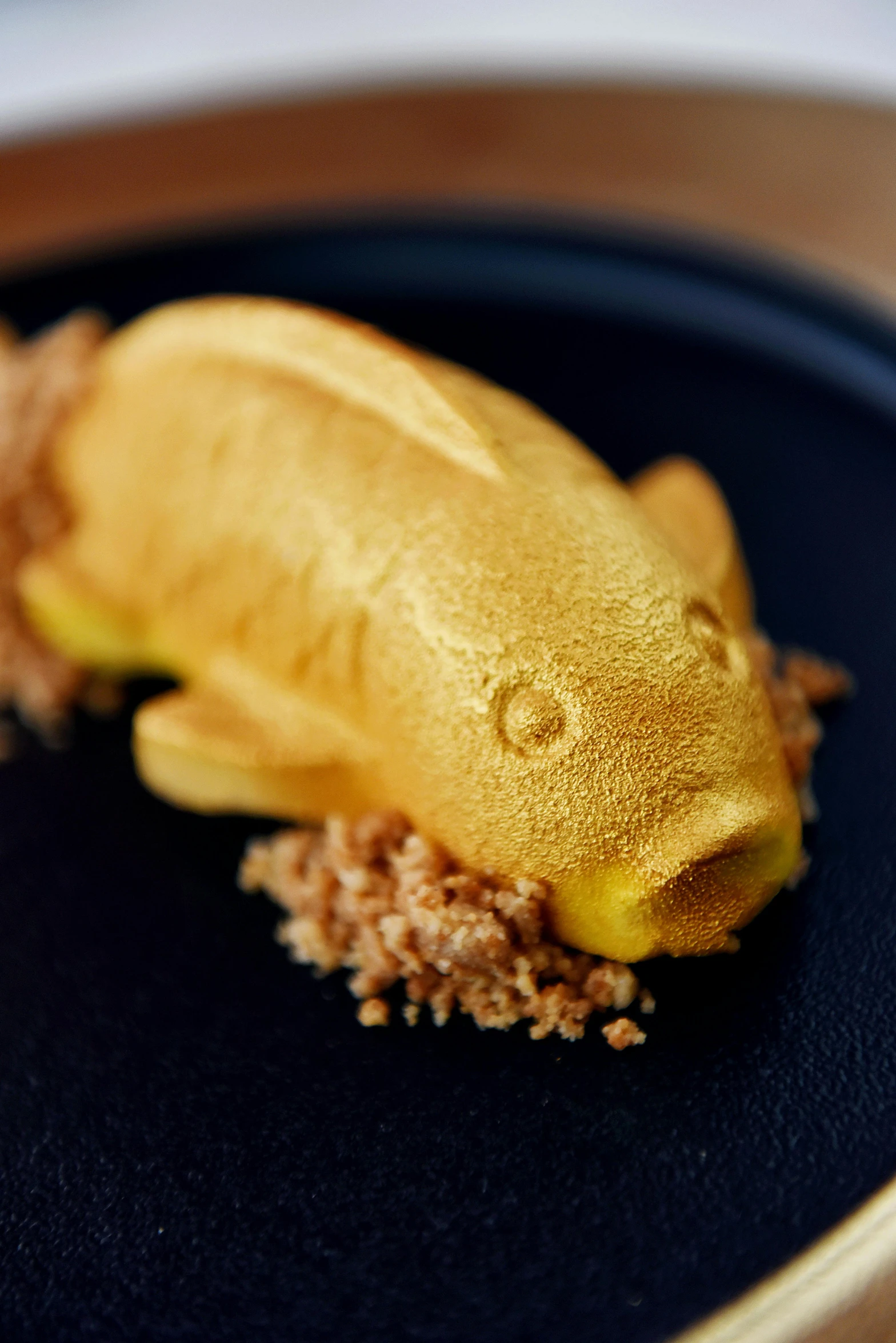a close up of a plate of food on a table, inspired by Kanō Naizen, sculpture made of gold, half fish, pastelle, thumbnail