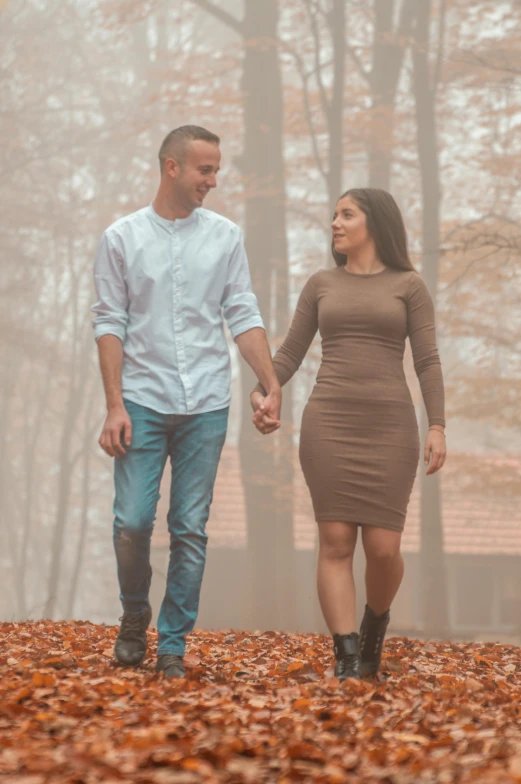 a man and woman walking through a foggy forest, a picture, happening, brown clothes, confident looking, indoor picture, trending photo