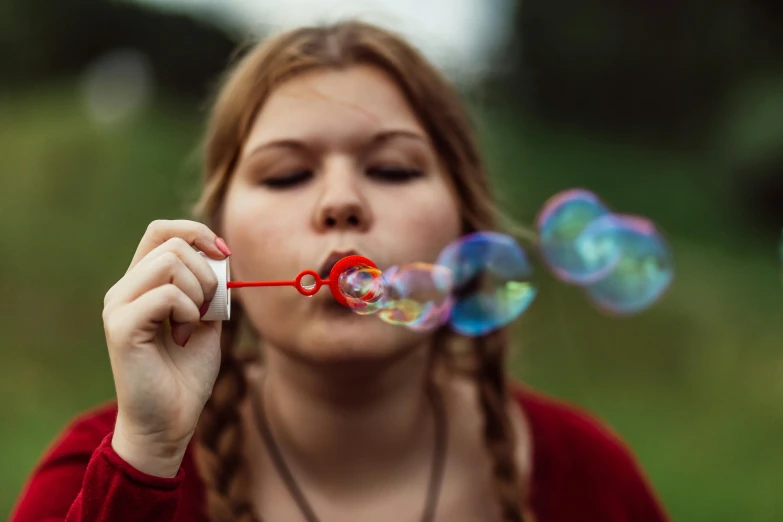 a woman blowing bubbles on top of a lush green field, by Adam Marczyński, pexels contest winner, teenage girl, bokeh ), barbecuing chewing gum, avatar image