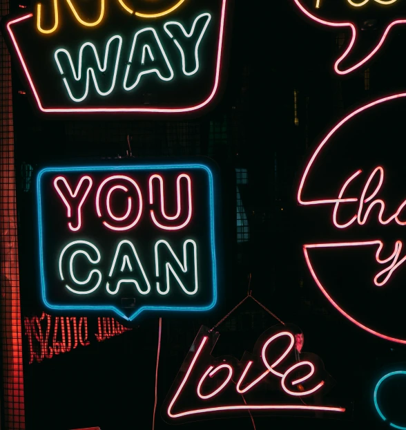 a group of neon signs hanging from the side of a building, trending on pexels, unconditional love, profile image, thank you, 1 9 8 0 s poster style