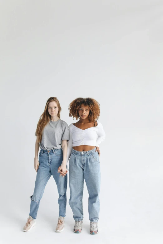 two women standing next to each other on a white background, trending on pexels, renaissance, ( ( ( wearing jeans ) ) ), grey backdrop, uwu, crop top