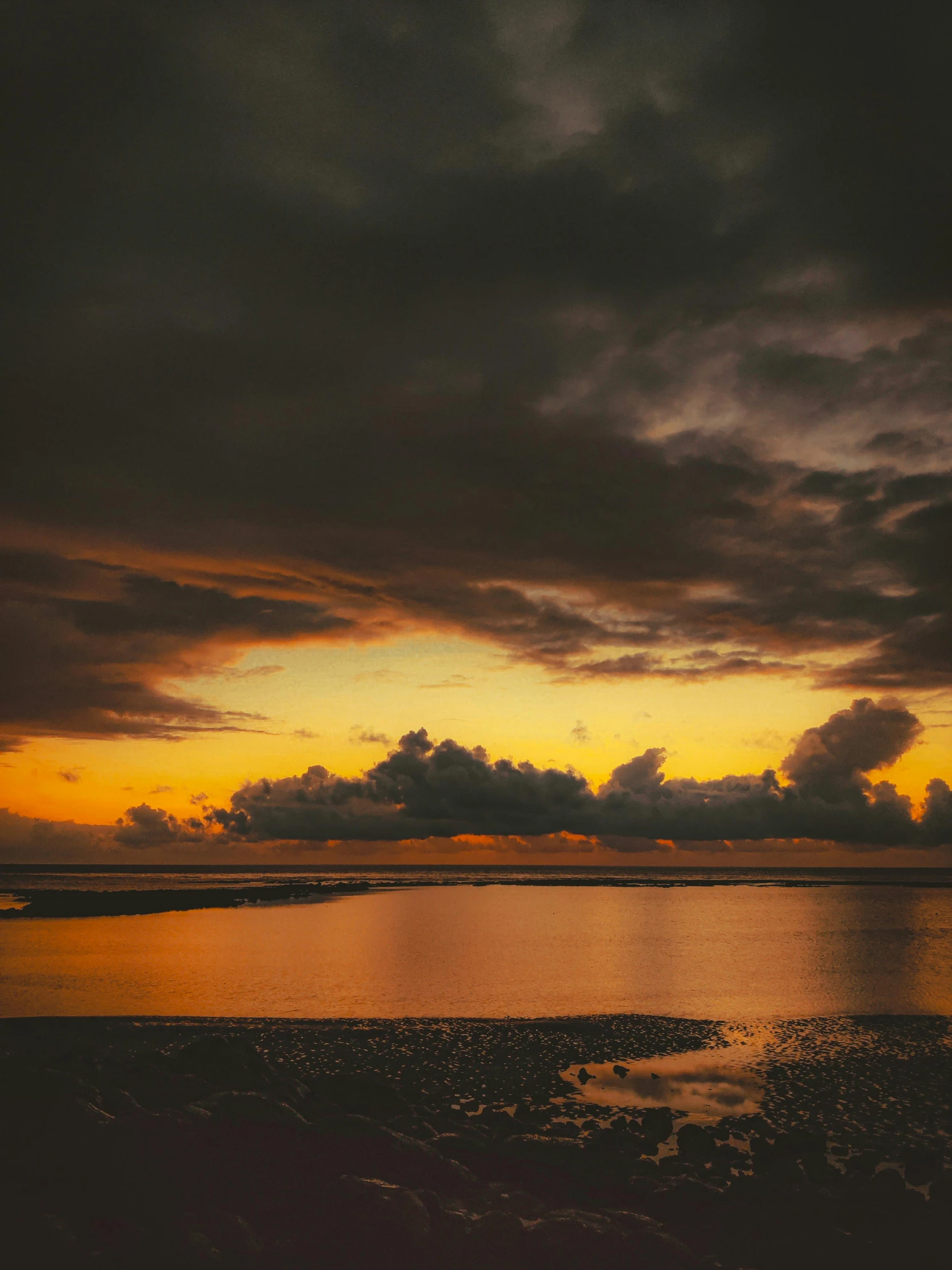 a large body of water under a cloudy sky, by Jan Tengnagel, unsplash contest winner, australian tonalism, shades of aerochrome gold, humid evening, seaview, medium format. soft light