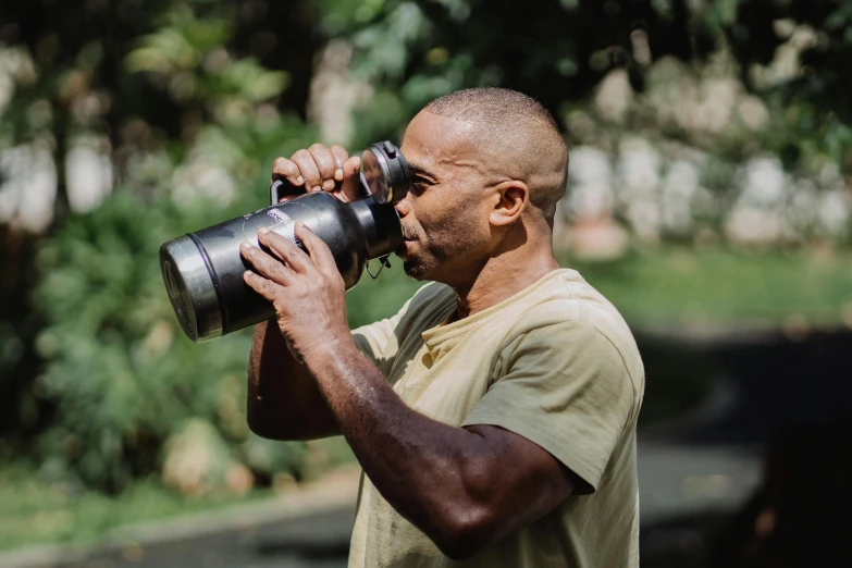 a man taking a picture with a camera, hydration, hasselblad photo, sweat, gardening