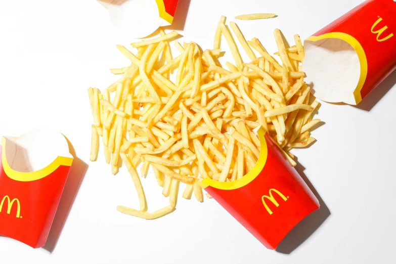 a pile of french fries sitting on top of a table, eating inside mcdonalds, minimalistic aesthetics, promo image, dezeen