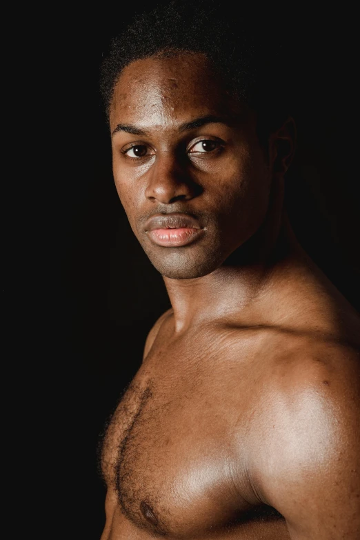 a shirtless man standing in front of a black background, inspired by Leonard Daniels, jaylen brown, close up portrait photo, in a boxing ring, headshot profile picture