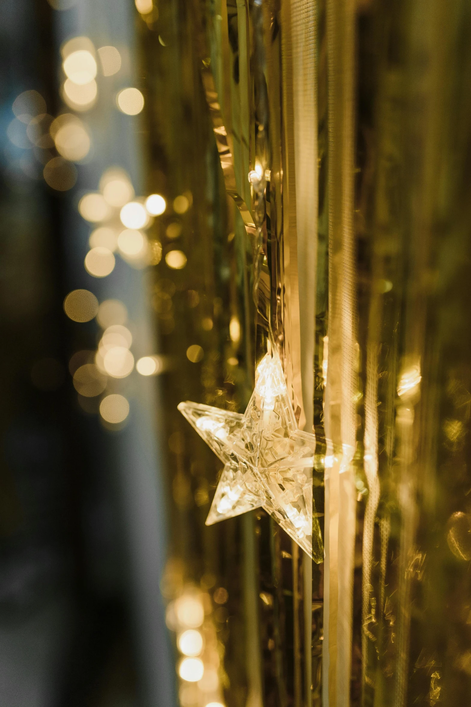 a close up of a star on a string of lights, light and space, draped in shiny gold and silver, transparent, stunning detail, beautiful surroundings