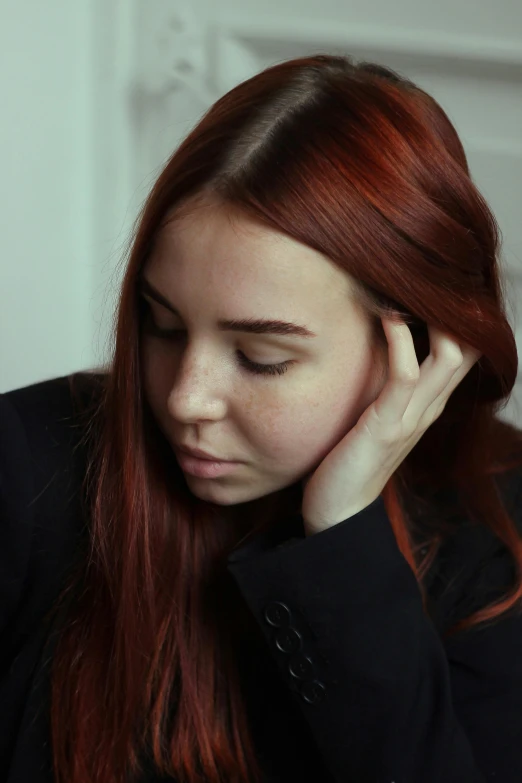 a woman sitting at a table with her hand on her head, trending on pexels, antipodeans, soft red hair, low quality photo, portrait of depressed teen, 15081959 21121991 01012000 4k