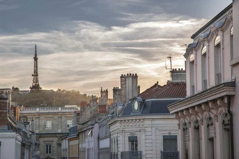 a city street with a clock tower in the distance, a photo, pexels contest winner, renaissance, pink and grey clouds, arkane lyon, square, dappled in evening light