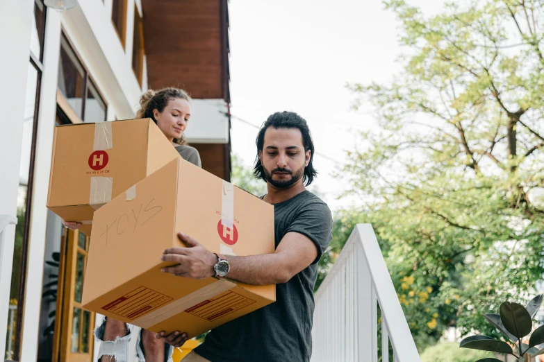 a man carrying a box on a porch, pexels contest winner, hurufiyya, jordan grimmer and natasha tan, upgrade to max, lachlan bailey, profile image