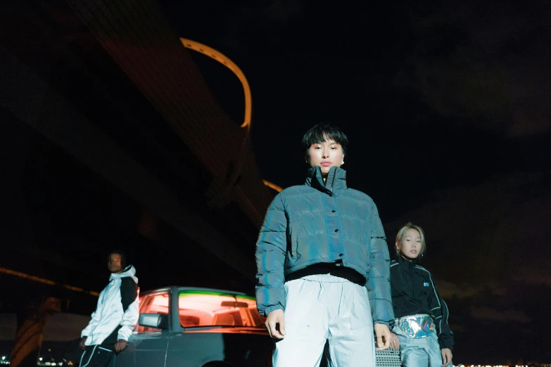 a group of people standing in front of a car, an album cover, inspired by Gang Hui-an, unsplash, she is wearing streetwear, reflective lighting, 15081959 21121991 01012000 4k, nvidia promotional image