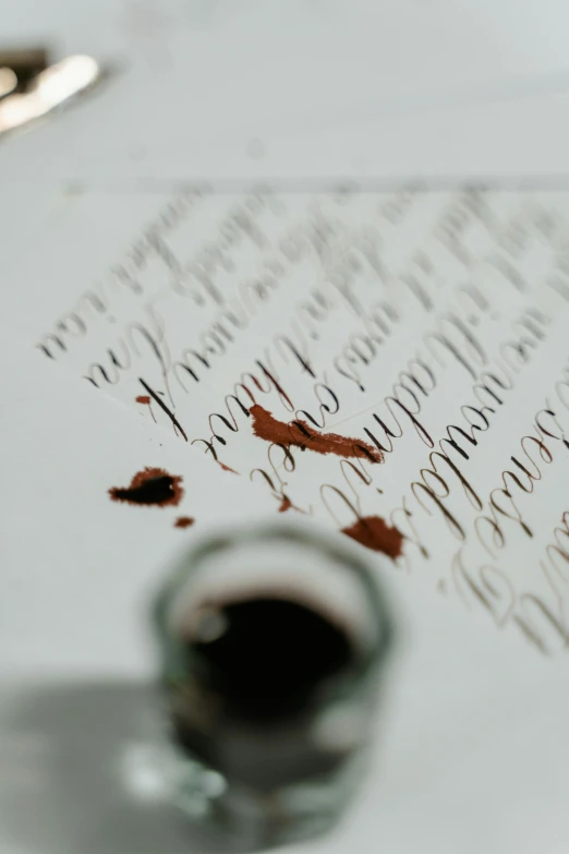 a cup of coffee sitting on top of a table, by Konrad Witz, pexels contest winner, letterism, scratched vial, wine, inks, on white paper