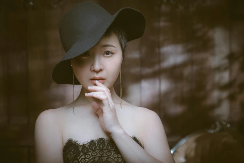 a woman in a black hat poses for a picture, inspired by Tang Yifen, pexels contest winner, art photography, pale fair skin, ethnicity : japanese, 奈良美智, thoughtful )