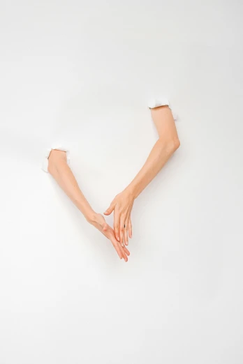 a person with their hands in the shape of a v, an album cover, inspired by Cornelia Parker, unsplash, conceptual art, white backdrop, skinny upper arms, ignant, floating