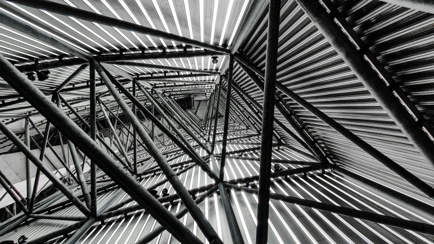 a black and white photo of a metal structure, inspired by Alexander Rodchenko, unsplash, abstract illusionism, mc escher!!, lines of lights, staircase, top down perspecrive