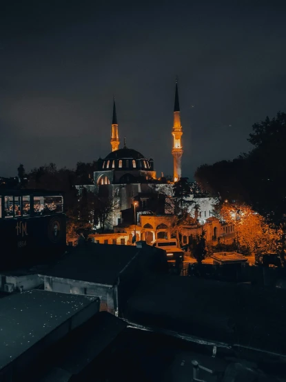 a view of a mosque lit up at night, an album cover, pexels contest winner, hurufiyya, city buildings on top of trees, turkish and russian, dark grey and orange colours, ☁🌪🌙👩🏾