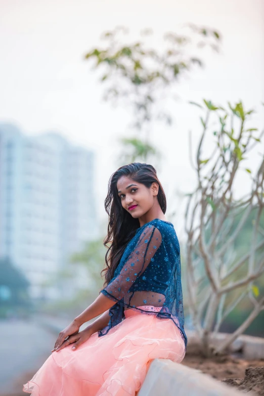 a woman in a pink and blue dress sitting on a ledge, by Max Dauthendey, pexels contest winner, assamese aesthetic, wearing crop top and miniskirt, headshot profile picture, 15081959 21121991 01012000 4k