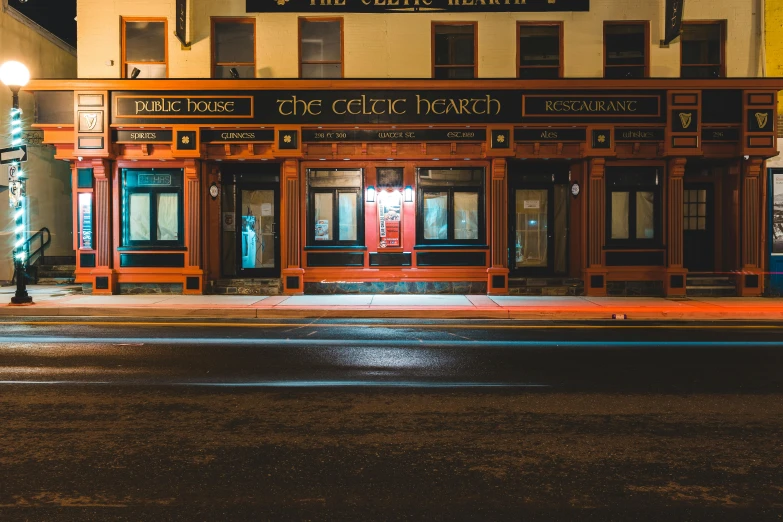 a building on a city street at night, celtic culture, the beach, profile image, local bar