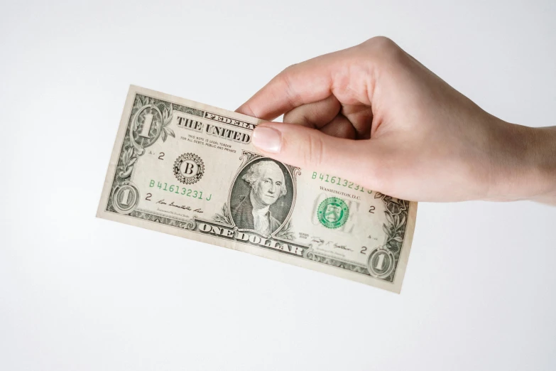 a person holding a one dollar bill in their hand, by Ben Zoeller, pexels, visual art, on a white background, instagram post, flat, 🤠 using a 🖥