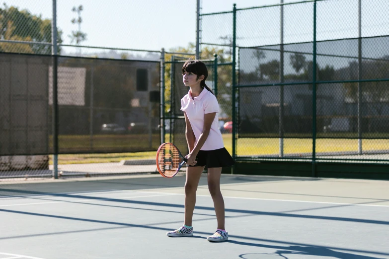 a woman standing on a tennis court holding a racquet, profile image, schools, damien tran, sunny day time