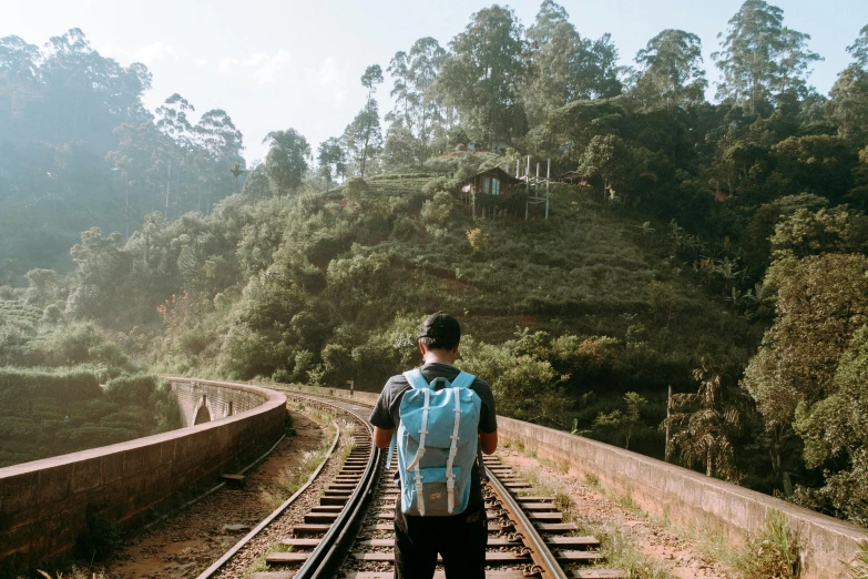 a couple of people standing on a train track, pexels contest winner, hurufiyya, a man wearing a backpack, sri lanka, 2 5 6 x 2 5 6 pixels, lachlan bailey