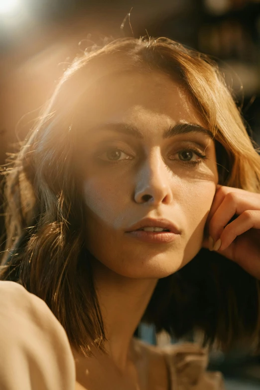 a woman sitting at a table with a cigarette in her mouth, inspired by Elsa Bleda, trending on pexels, photorealism, imogen poots as holy paladin, looking off into the sunset, emmy rossum, exhausted face close up