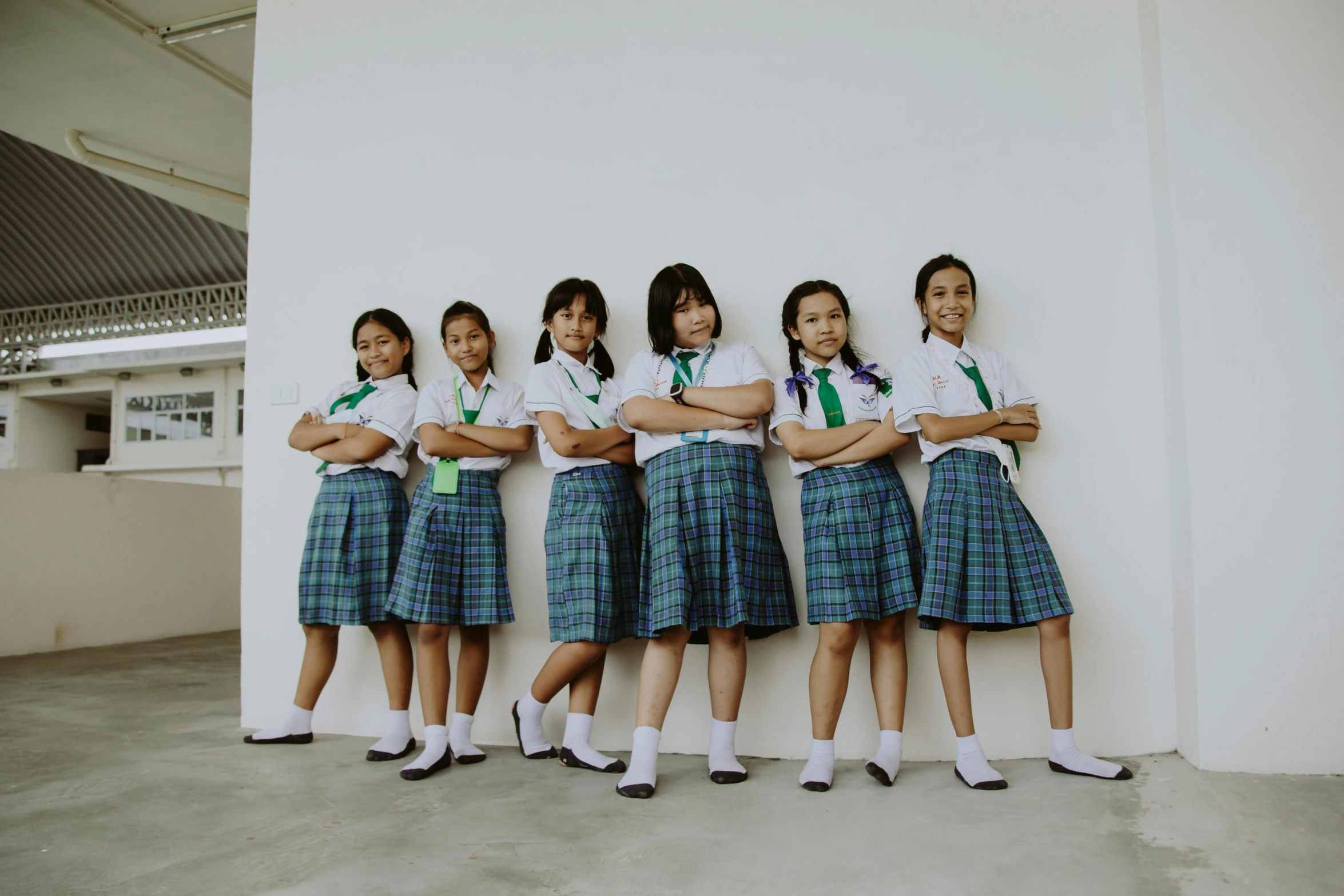 a group of girls standing next to each other, pexels contest winner, ashcan school, white shirt and green skirt, ren heng, confident, ƒ5.6