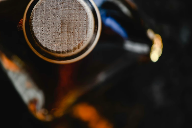 a close up of a bottle of wine, a macro photograph, unsplash, coffee, thumbnail, woodfired, 33mm photo