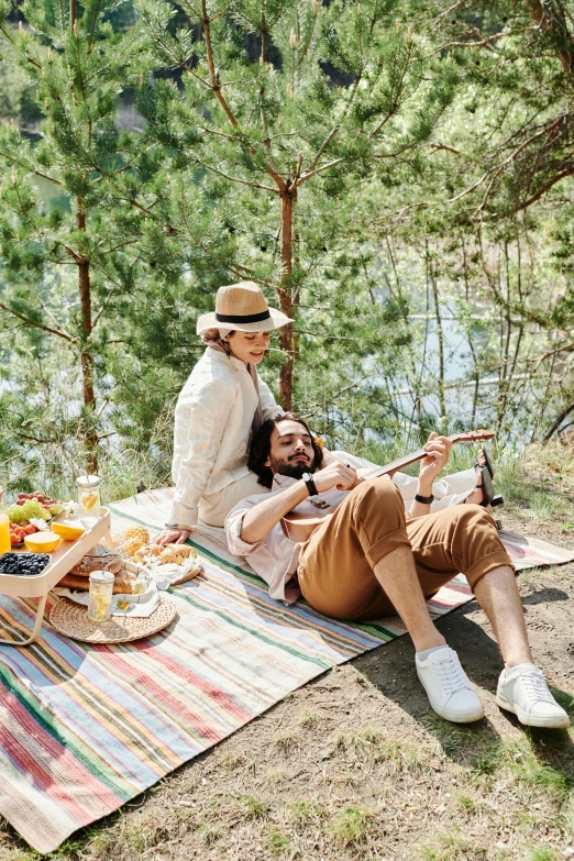 a couple of people that are sitting on a blanket, having a picnic, wearing sunglasses and a hat, arrendajo in avila pinewood, on a canva