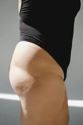 a close up of a person wearing a black shirt, insanely inflated hips, profile image, bare thighs, bumpy skin