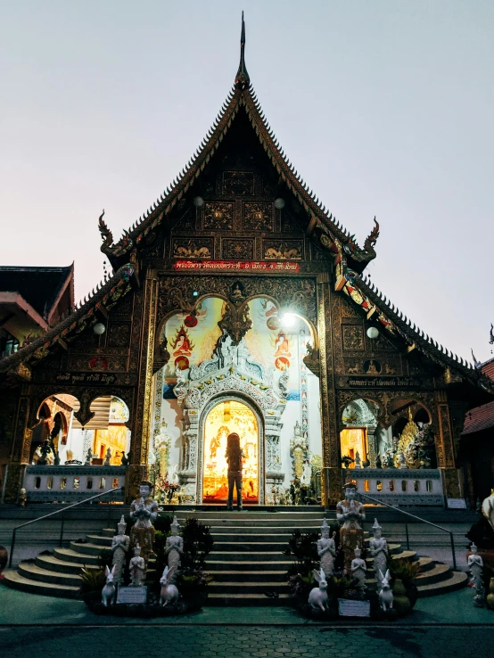 a group of people standing in front of a building, thai temple, during the night, at dawn, dmt temple