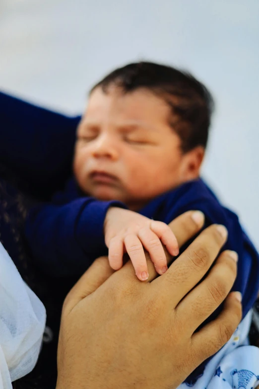 a woman holding a baby in her arms, by Dan Scott, unsplash, symbolism, multiple stories, hands crossed, prince, 2030