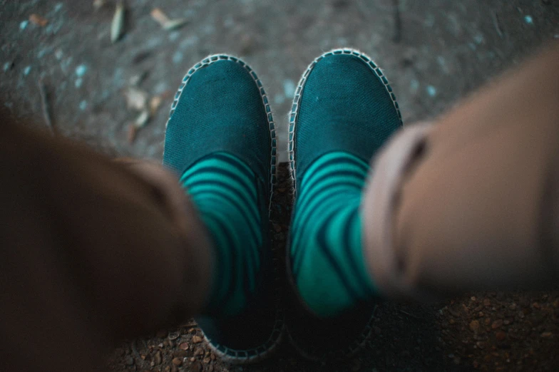 a person wearing green socks and blue shoes, pexels contest winner, dark teal, striped, felt, slides