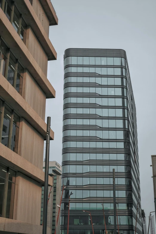 a very tall building sitting in the middle of a city, inspired by David Chipperfield, flickr, wellington, side view of a gaunt, slight overcast, hoog detail