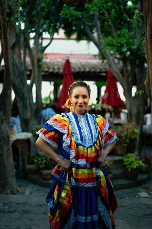 a woman in a colorful dress posing for a picture, inspired by Gina Pellón, pexels contest winner, happening, tlaquepaque, colorful uniforms, dilraba dilmurat, ::