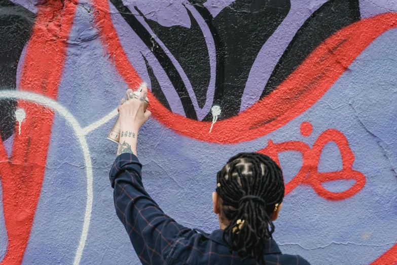 a woman is painting graffiti on a wall, by artist, pexels, post malone, essence, instagram photo, on artstastion