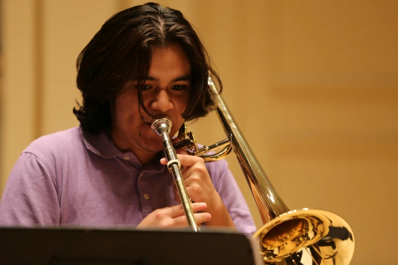 a woman in a purple shirt playing a trombone, student, asher duran, details, performing