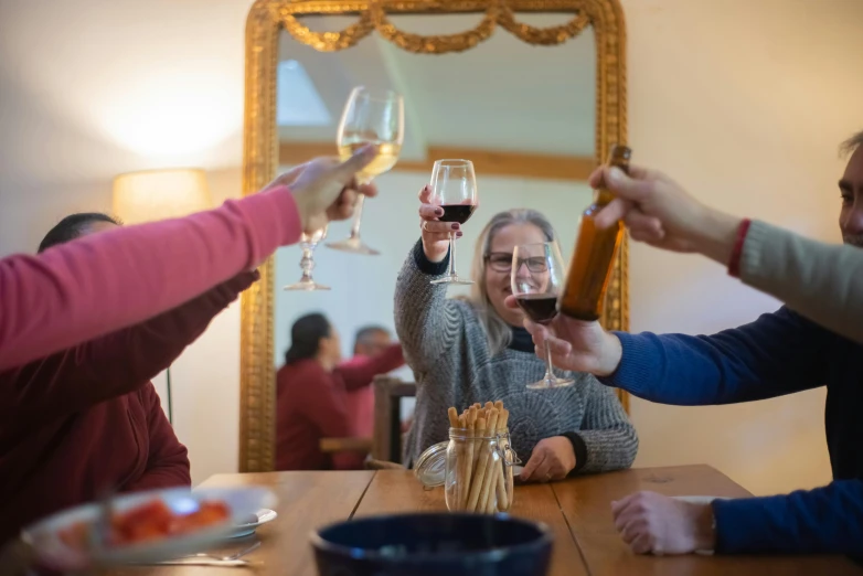 a group of people toasting with wine glasses, a portrait, by Carey Morris, pexels contest winner, delightful surroundings, avatar image, at home, triumphant pose