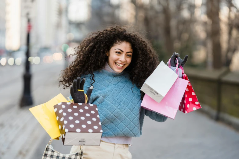 a woman walking down a street holding shopping bags, pexels contest winner, happening, curly afro, happy girl, high quality product image”, thumbnail