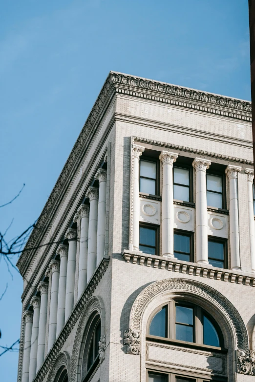 a clock that is on the side of a building, inspired by Balcomb Greene, trending on pexels, neoclassicism, viewed from the side, large overhangs, louis sullivan, portland oregon